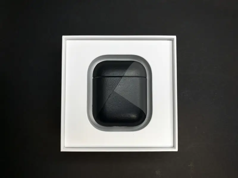 A pair of earbuds in their open box