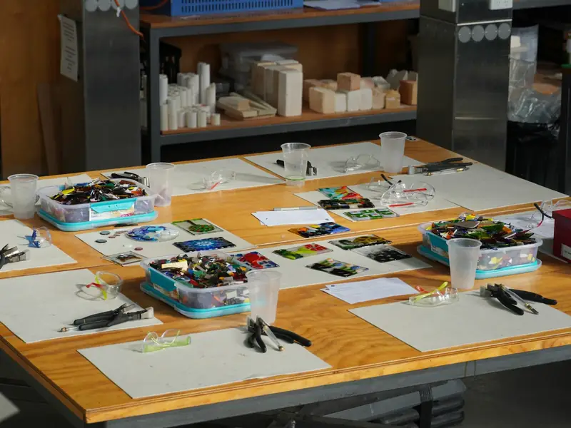 A workshop table laid out with art supplies