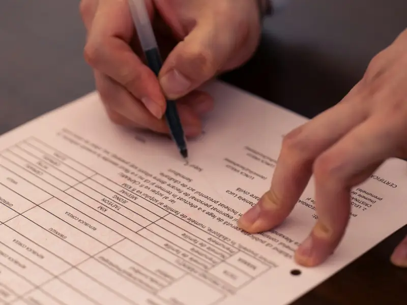 A person filling in a paper form