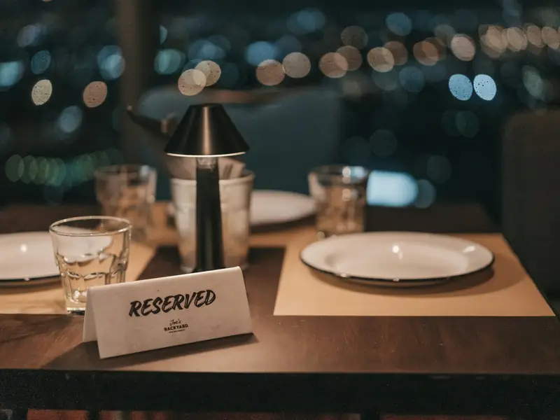 A 'Reserved' card on a set restaurant table