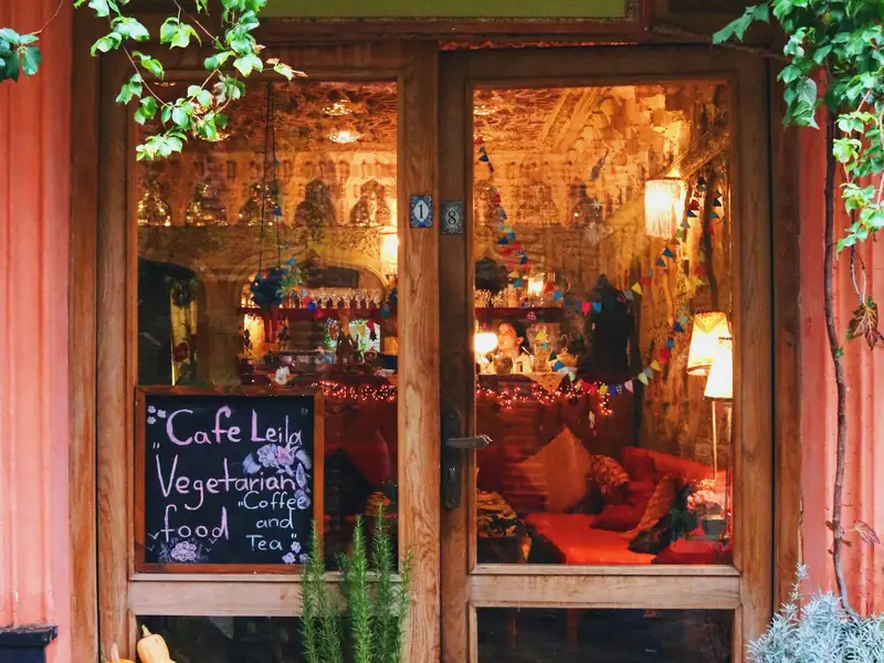 The entrance of a small shop with plants by the door