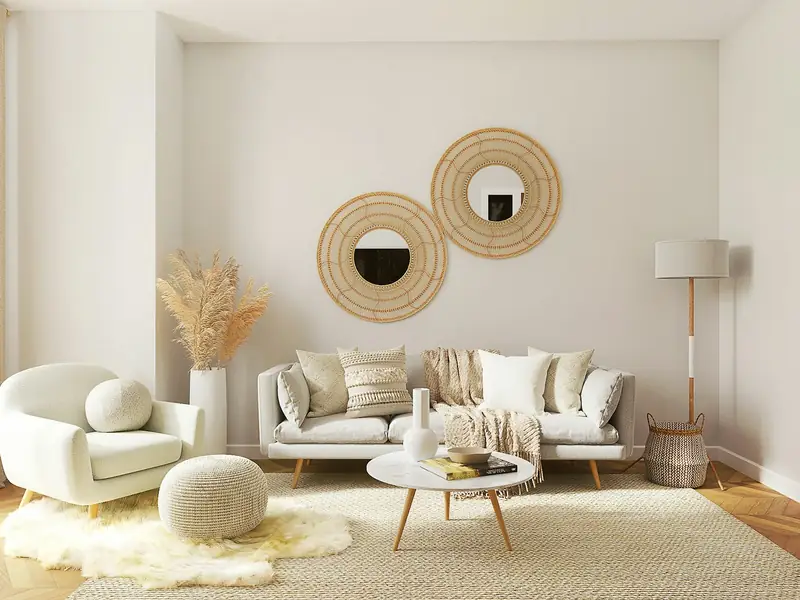 A bright living room with round mirrors on the wall