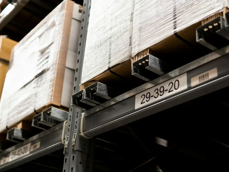 Labelled shelves of boxes in a warehouse