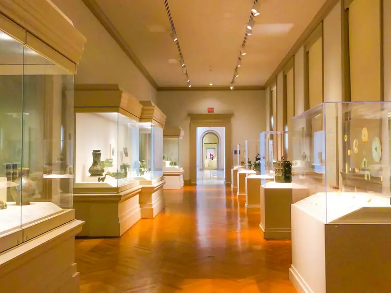 Glass display cases along a museum gallery