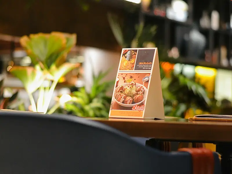A menu card standing on a café table